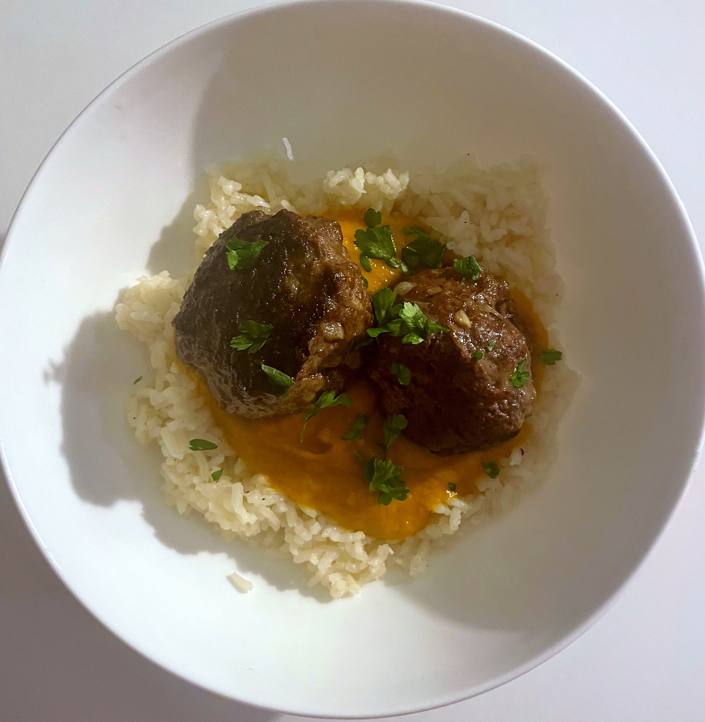 Spiced beef meatball bowl with carrot puree and aromatic rice