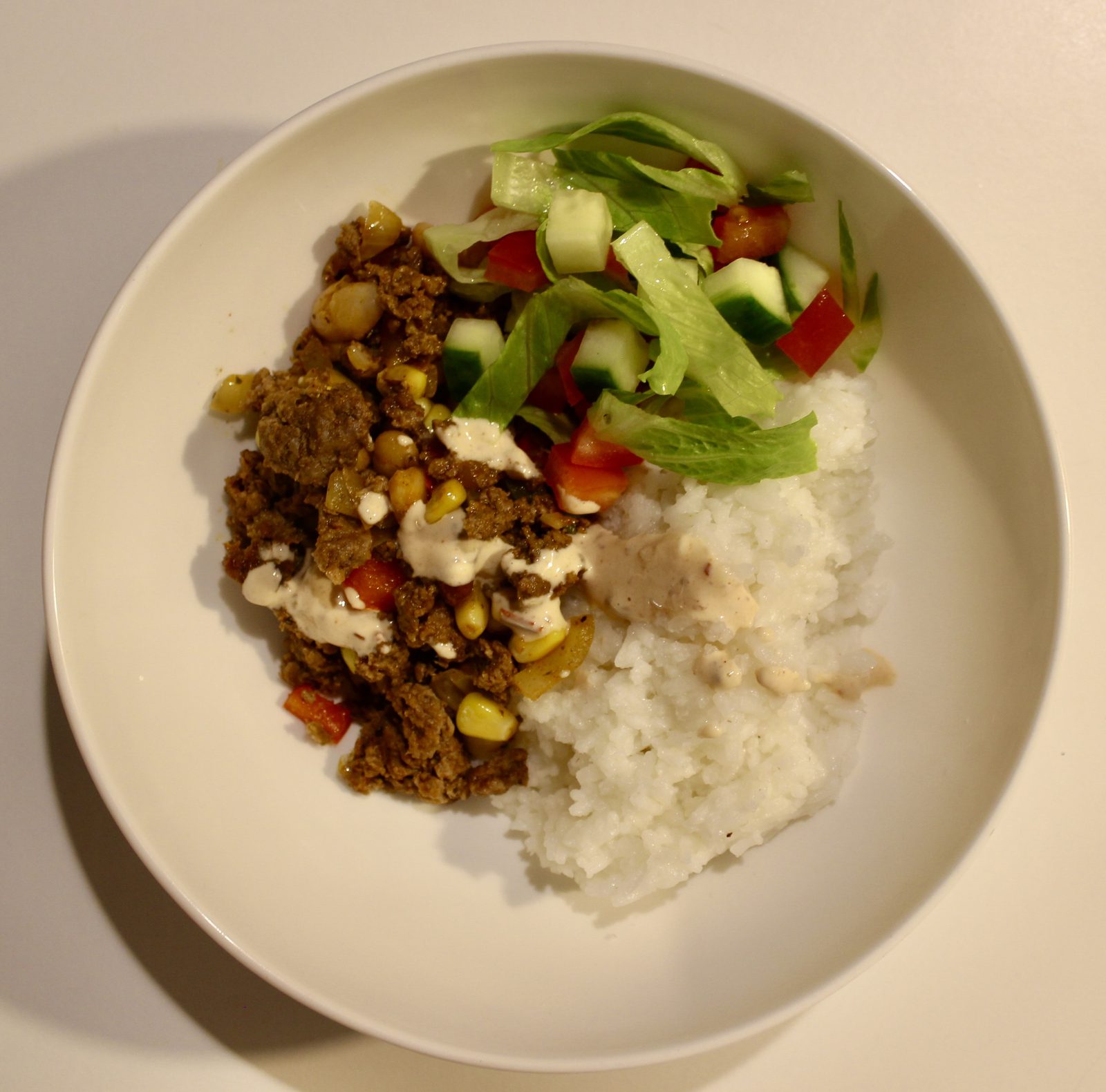 Beef mince burrito bowl with rice, salad and chipotle yoghurt sauce