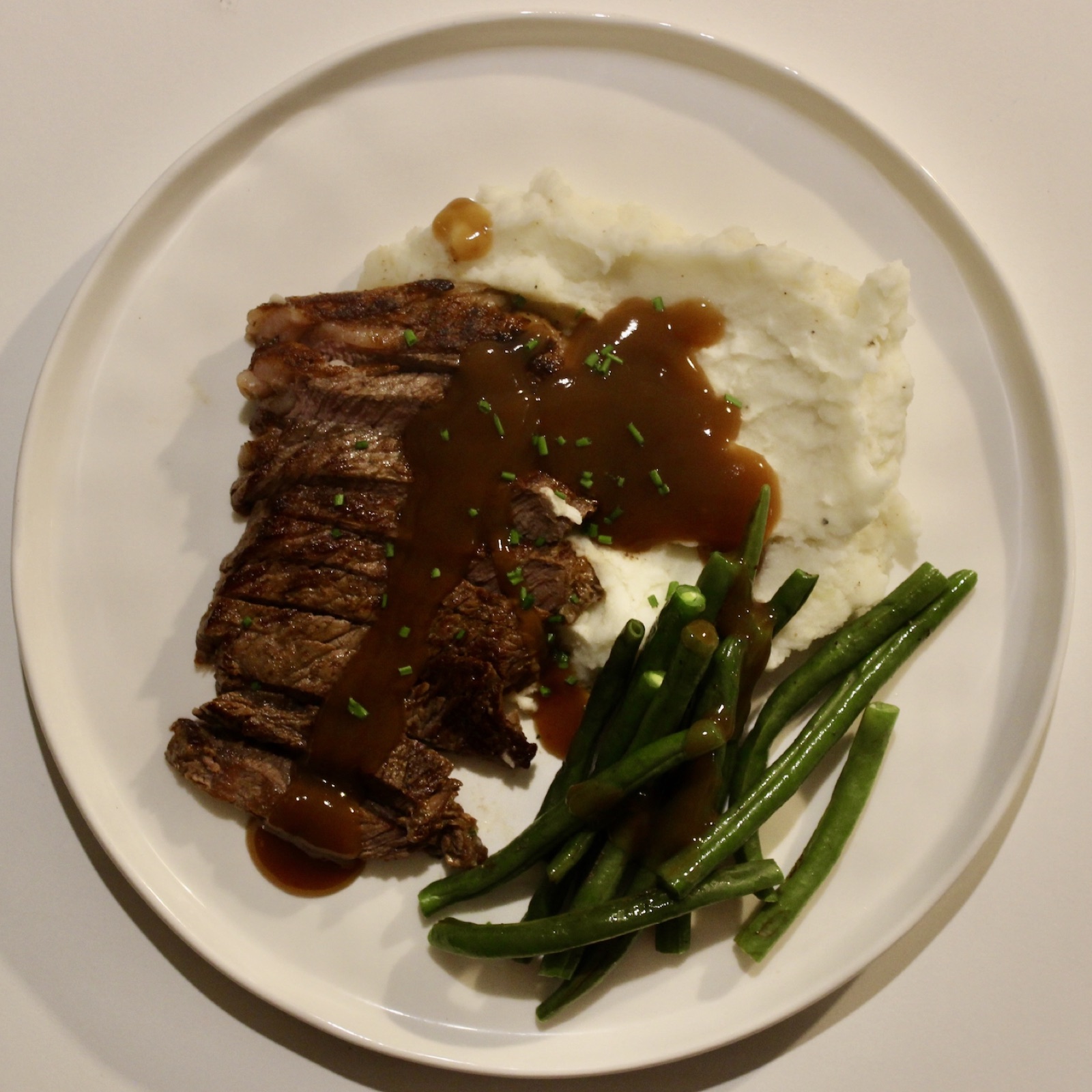 Steak with mashed potato, green beans and gravy